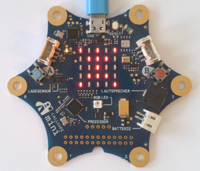 Hands connecting wires to a board